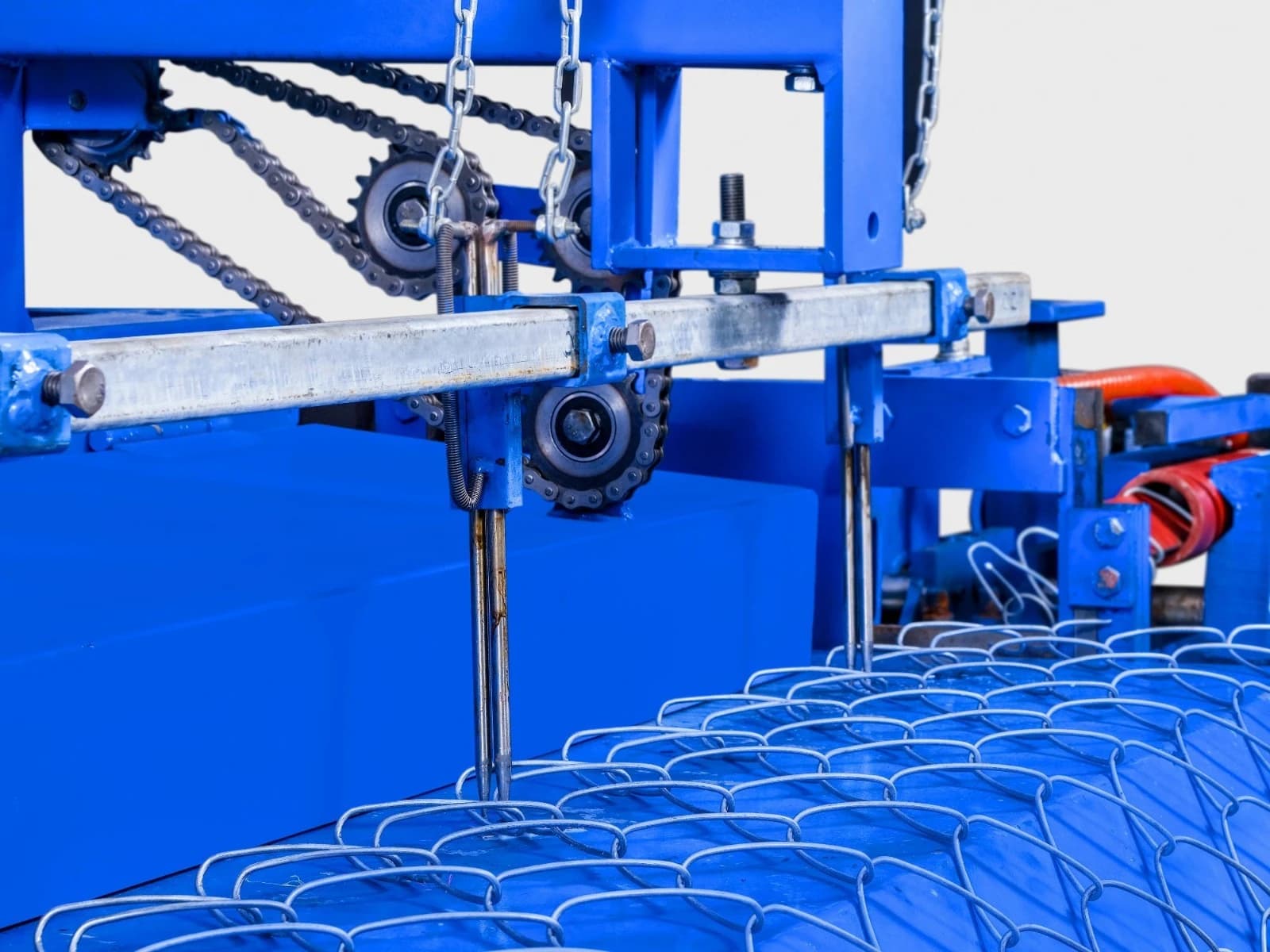 Chain link mesh being woven on a fence-making machine